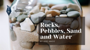 A jar containing rocks, pebbles, sand and water
